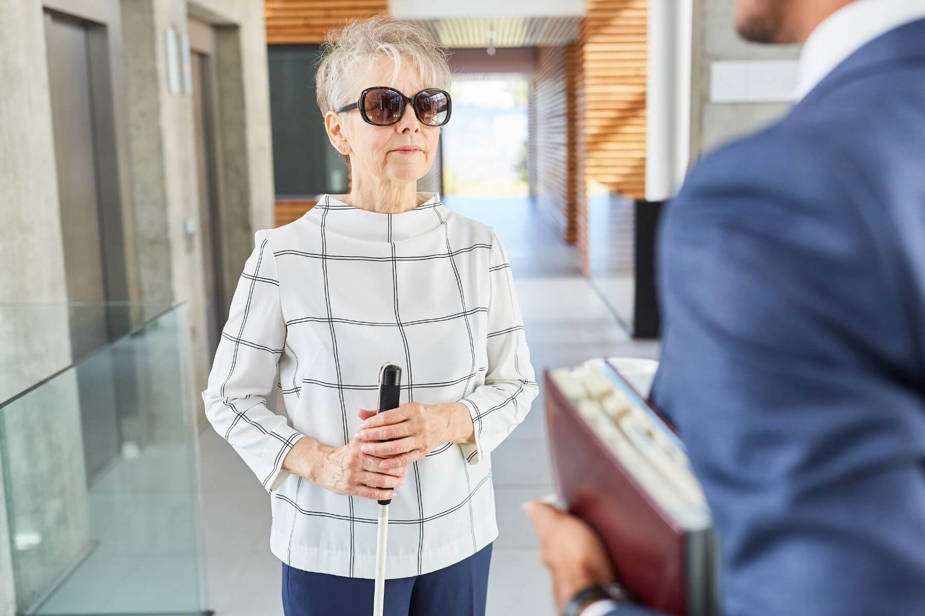 visually impaired woman talking to a man at the office