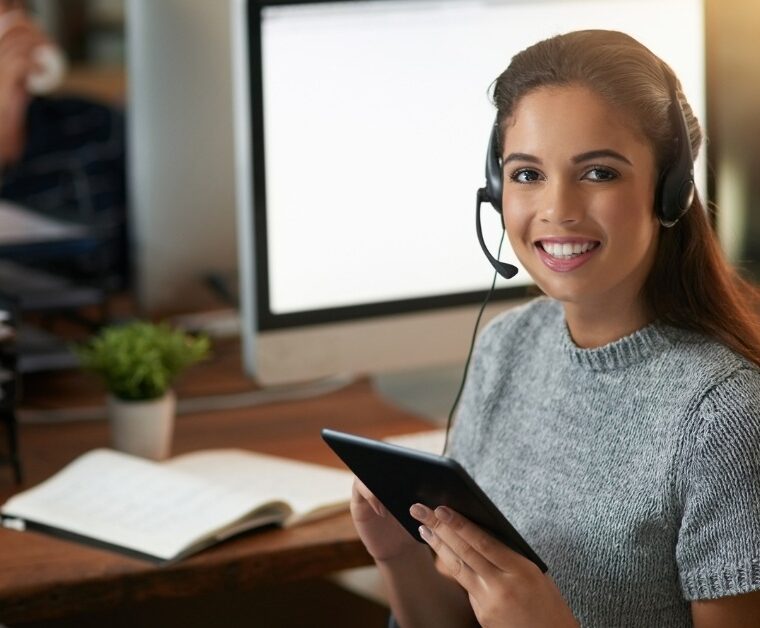 woman talking on headphones at the office